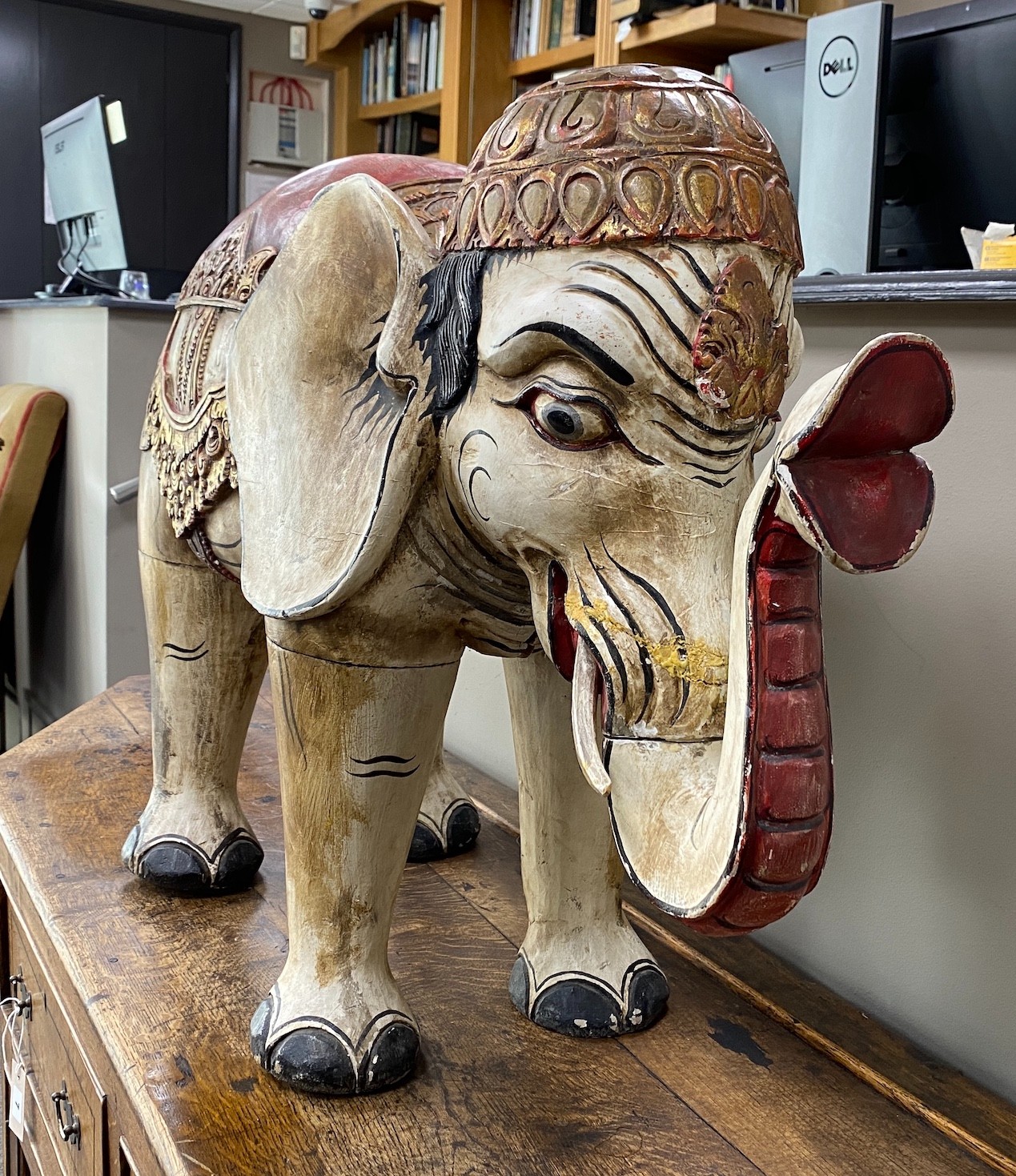 A large Indonesian painted wood model of an elephant, length 92cm, height 60cm